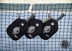 Honolulu Sword & Shield paddles in covers on a pickleball net